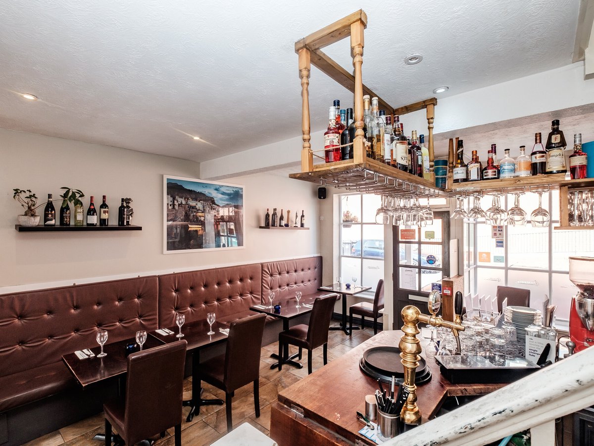 The bar at Giuseppes with leather seating and shelves of Italian wine
